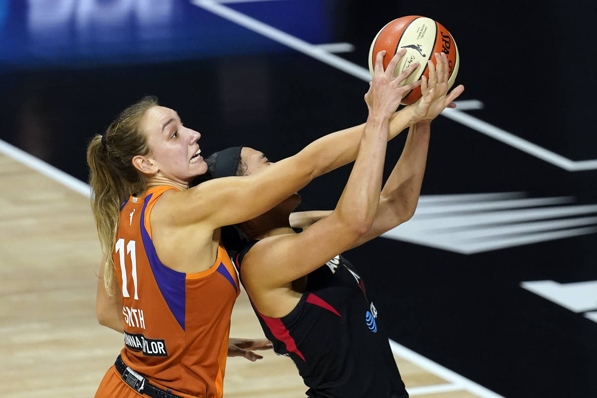 Phoenix Mercury forward Alanna Smith (11) fouls Las Vegas Aces forward Dearica Hamby (5) during ...