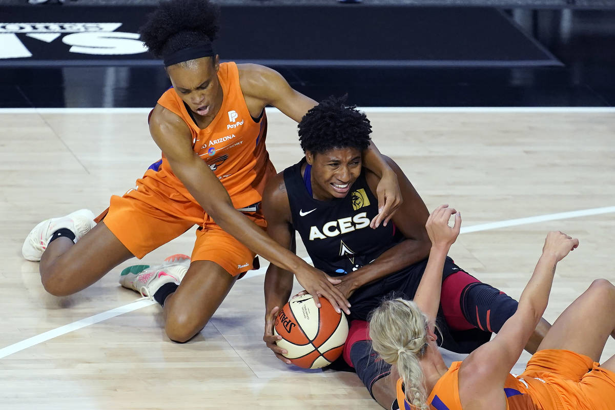 Phoenix Mercury forward Brianna Turner (21) and guard Sophie Cunningham (9) try to steal the ba ...