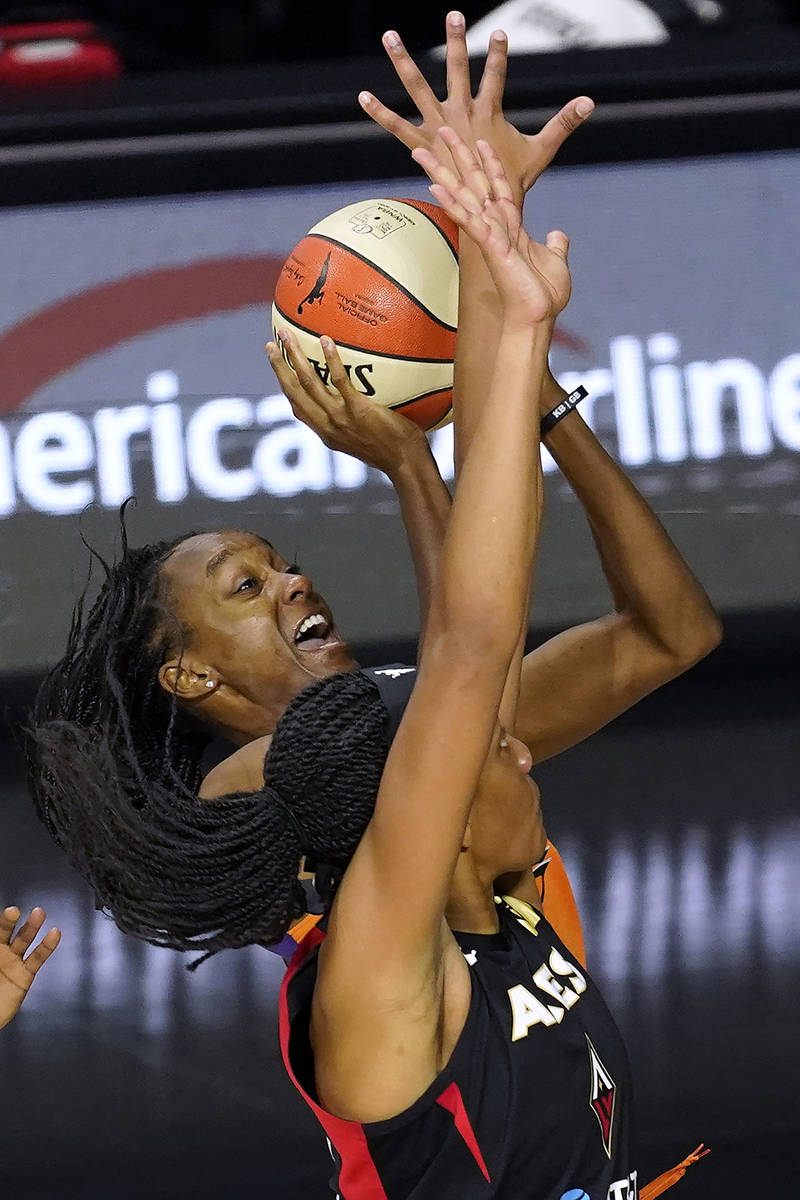 Phoenix Mercury guard Shatori Walker-Kimbrough shoots over Las Vegas Aces center A'ja Wilson (2 ...