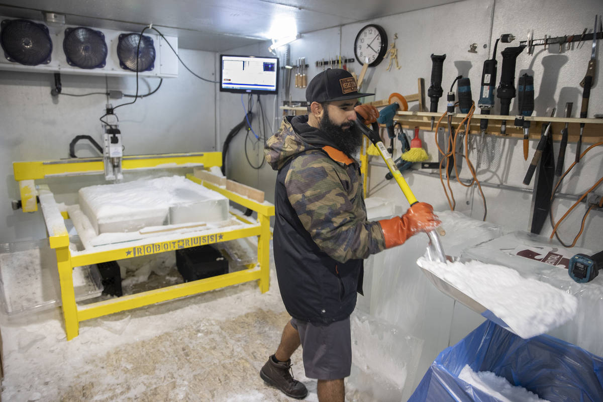 Marco Villarreal, known as "Vegas Ice Man," shovels freshly made snow on Tuesday, Sep ...
