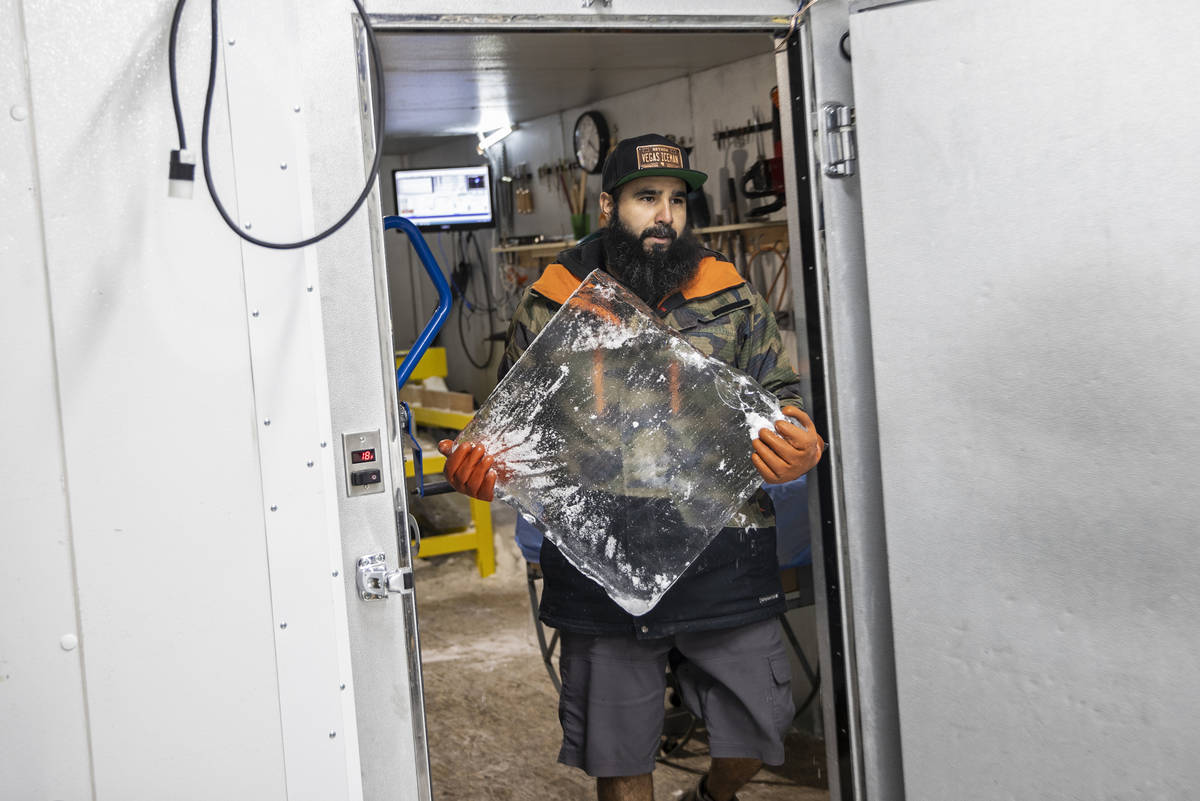 Marco Villarreal, known as "Vegas Ice Man," carries a fresh block of ice into his scu ...