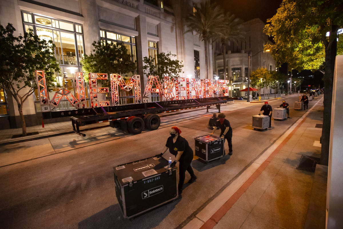 Entertainment workers push road cases past a "We Make Events" sign as The Smith Cente ...
