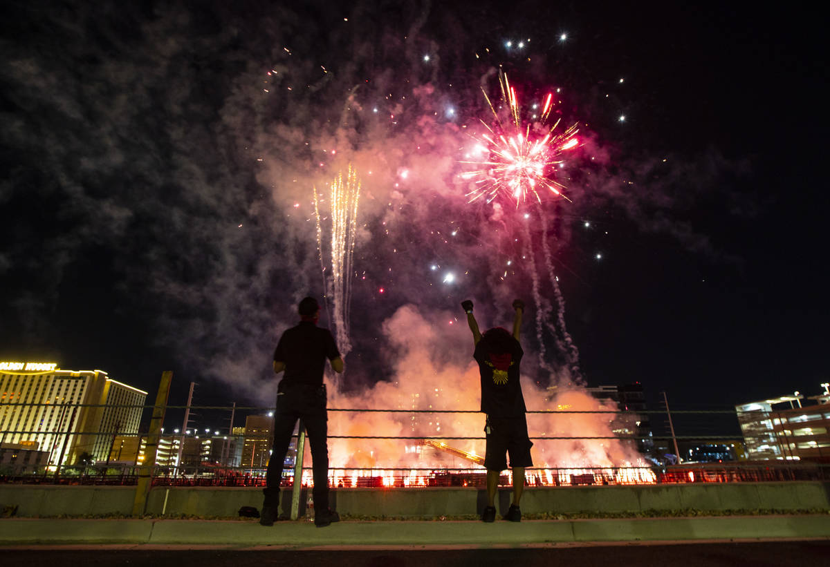 Entertainment workers watch as fireworks go off at the Core Arena at the Plaza for the "Red Ale ...
