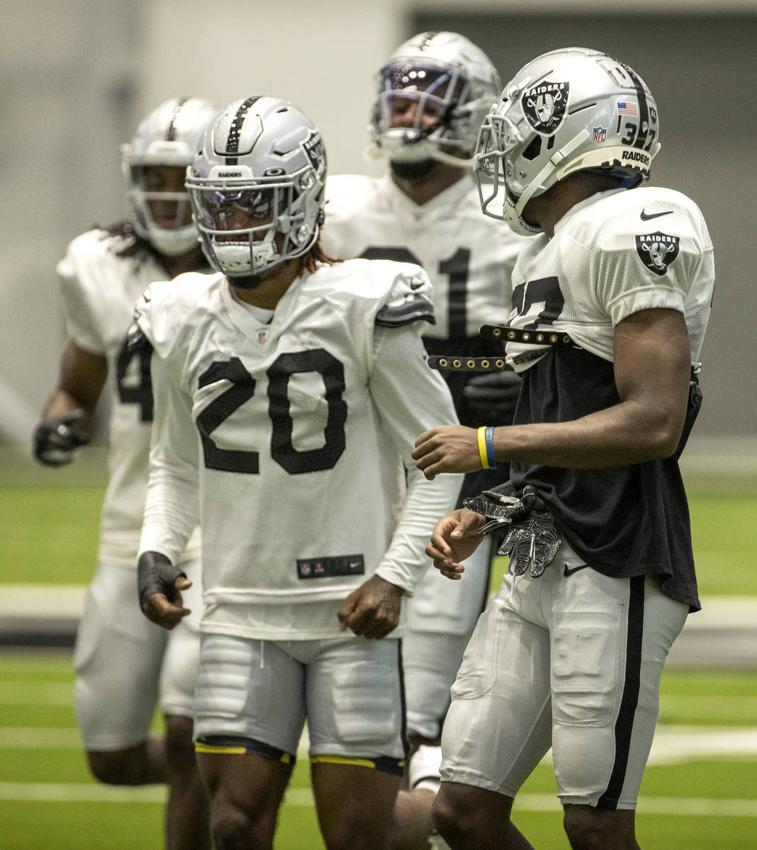 Las Vegas Raiders cornerback Trayvon Mullen (27, right) looks back to teammate cornerback Damon ...