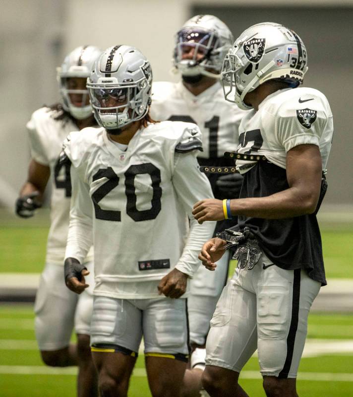 Las Vegas Raiders cornerback Trayvon Mullen (27, right) looks back to teammate cornerback Damon ...
