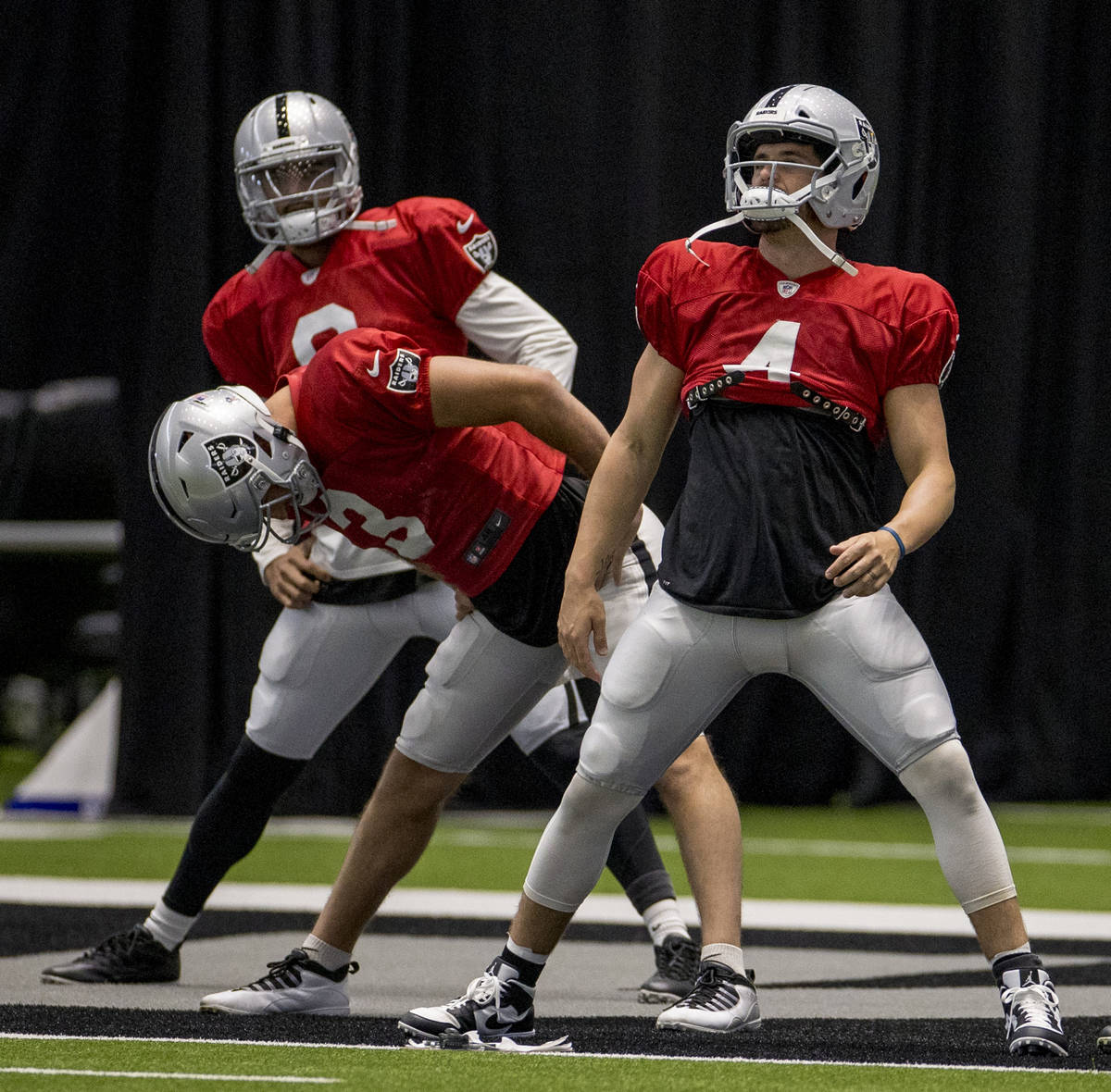 Las Vegas Raiders quarterback Derek Carr (4, from front), quarterback Nathan Peterman (3) and q ...