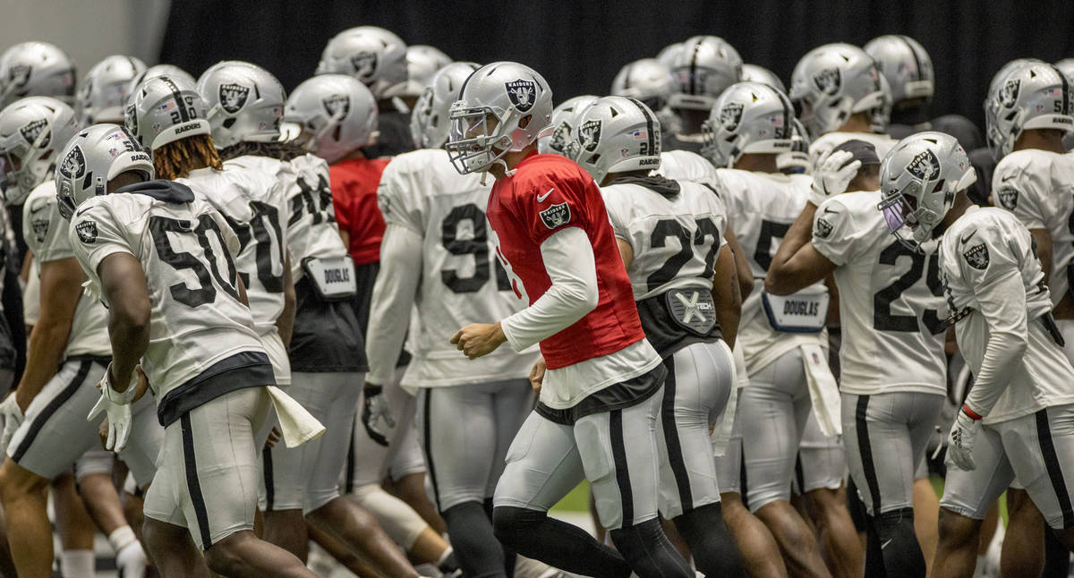 Las Vegas Raiders quarterback Marcus Mariota (8) runs off the field during warm ups at the Inte ...