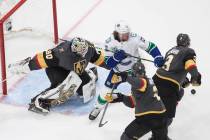 Vancouver Canucks' Tyler Toffoli (73) and Vegas Golden Knights' Zach Whitecloud (2) and Brayden ...