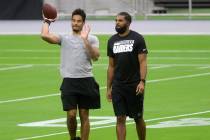 Las Vegas Raiders wide receiver Keelan Doss, left, and wide receiver Tyrell Williams walk on th ...