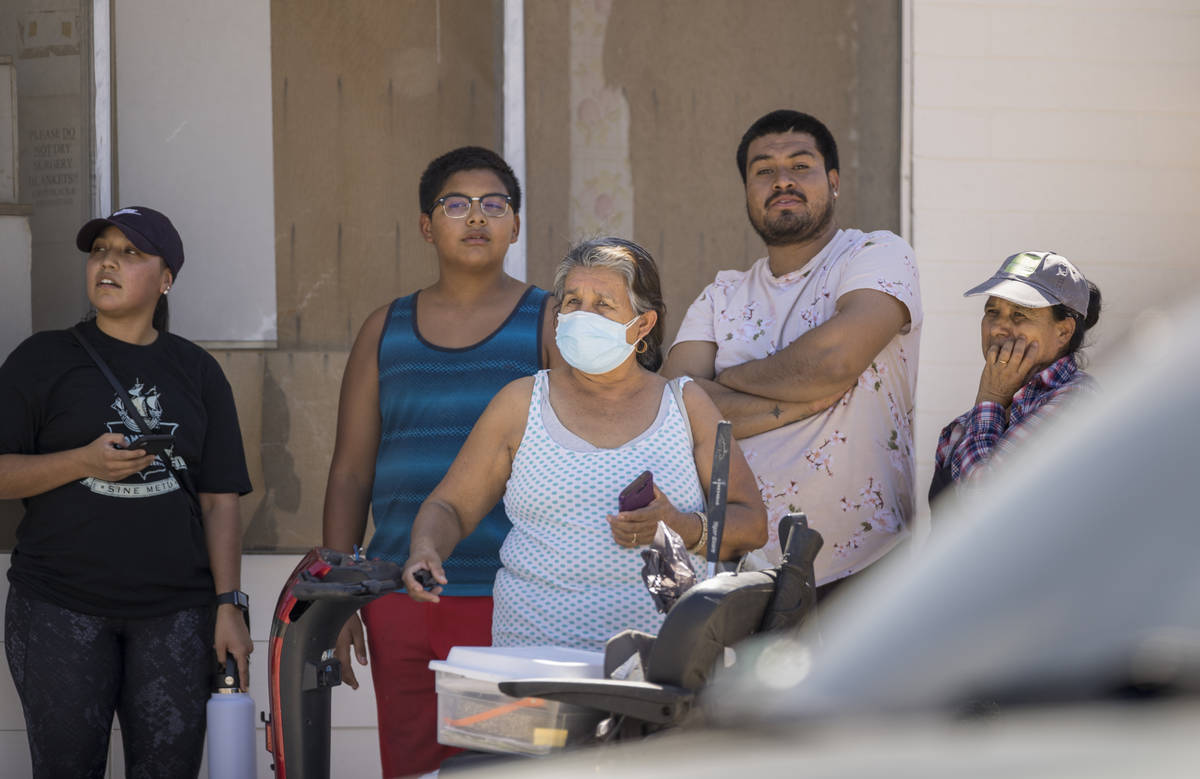 Neighbors watch as Las Vegas firefighters battle a house fire on 5400 block of West Pebble Beac ...