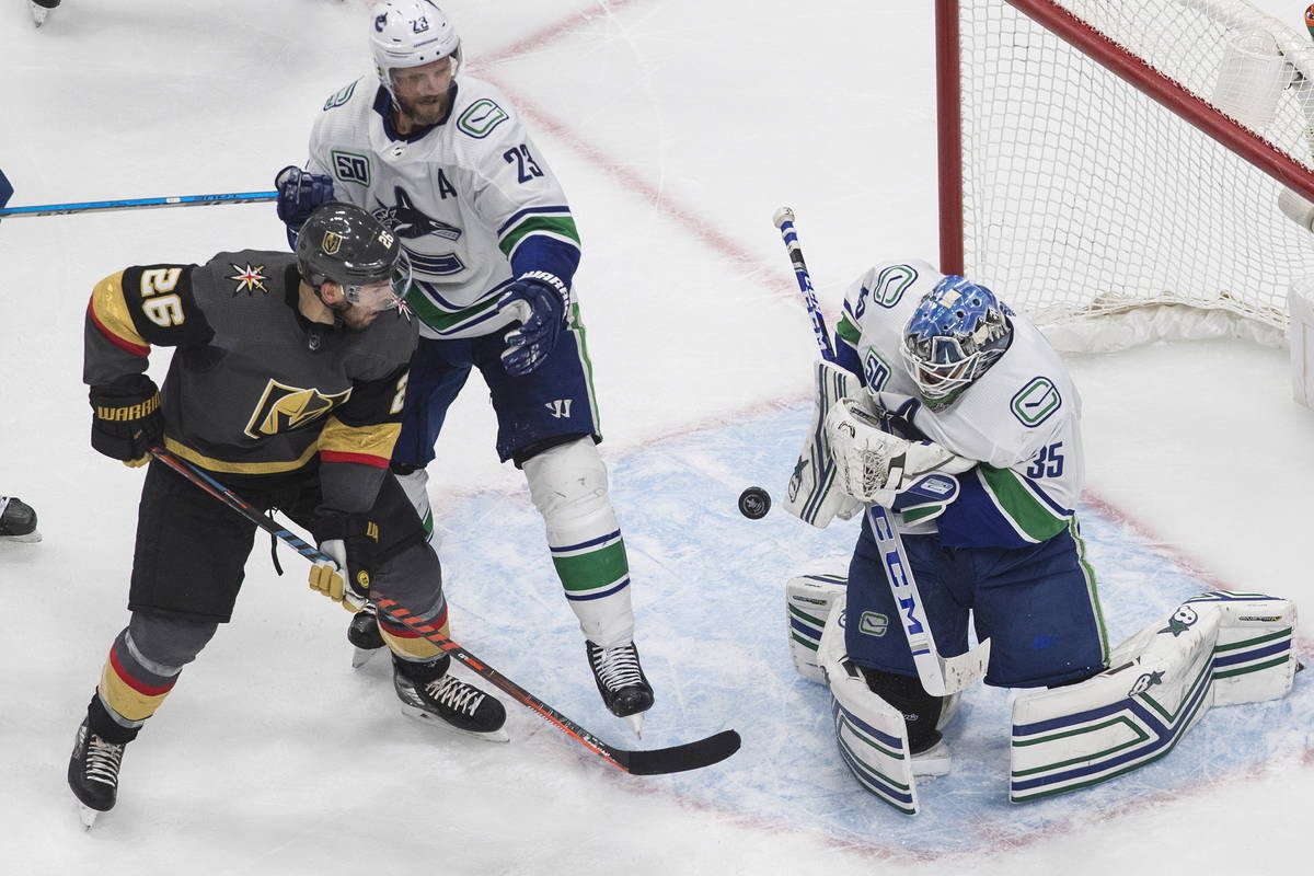 Vancouver Canucks goalie Thatcher Demko (35) makes a save as Vegas Golden Knights' Paul Stastny ...