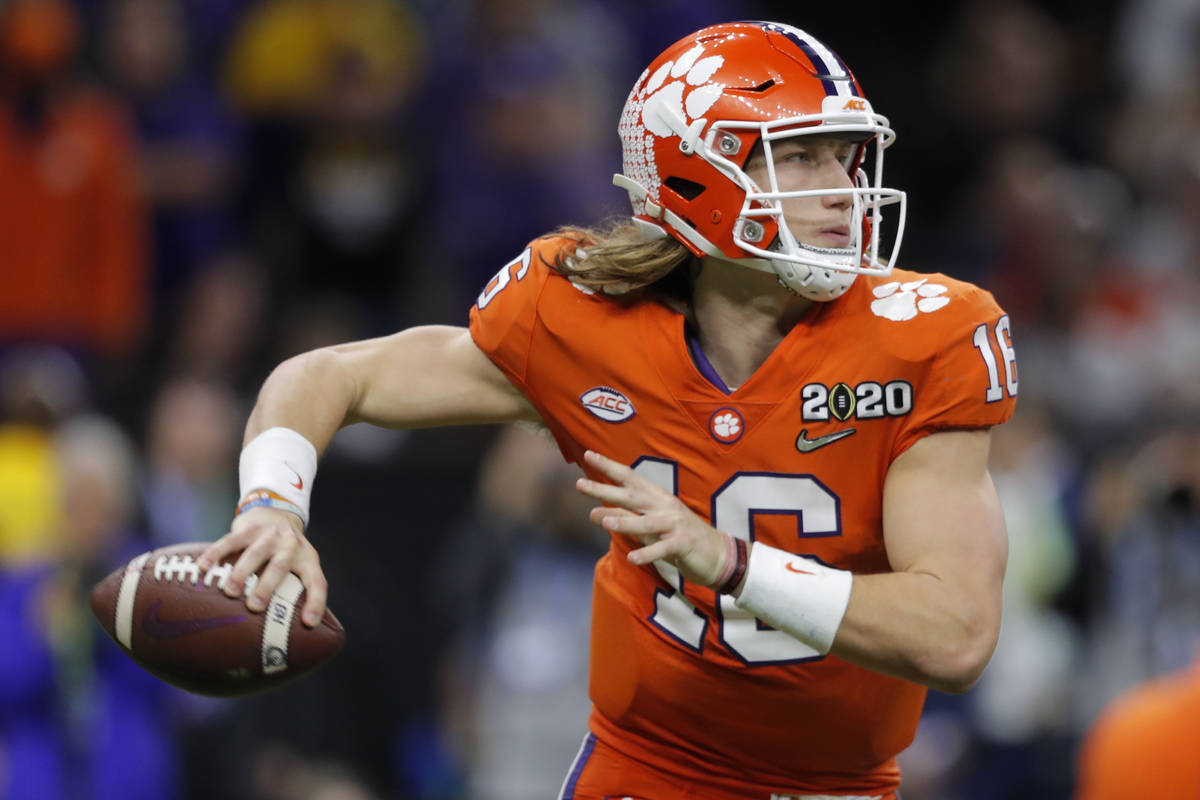 FILE - In this Jan. 13, 2020, file photo, Clemson quarterback Trevor Lawrence looks to pass aga ...