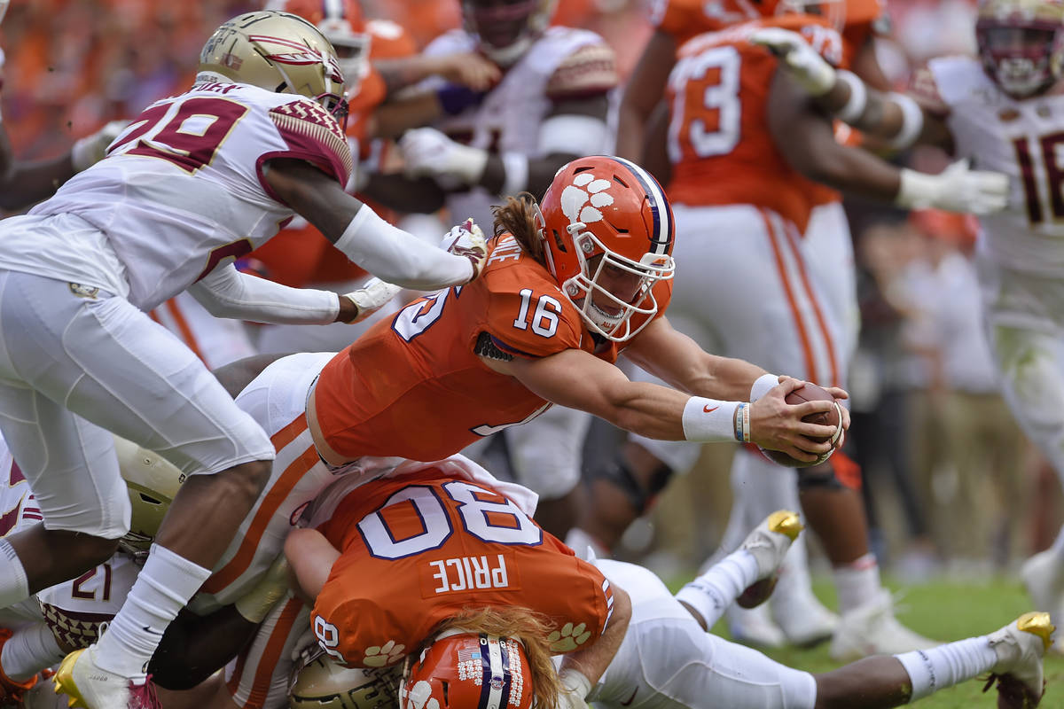 FILE - In this Oct. 12, 2019, file photo, Clemson quarterback Trevor Lawrence (16) stretches ou ...
