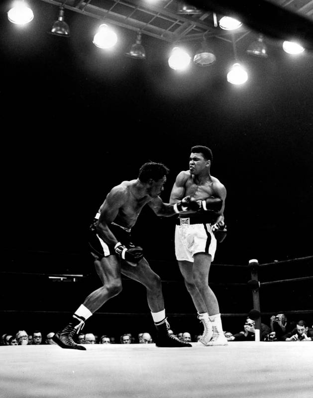 Cassius Clay exchanges punches with Charley Powell in the first round of the scheduled 10-round ...
