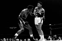 Cassius Clay exchanges punches with Charley Powell in the first round of the scheduled 10-round ...