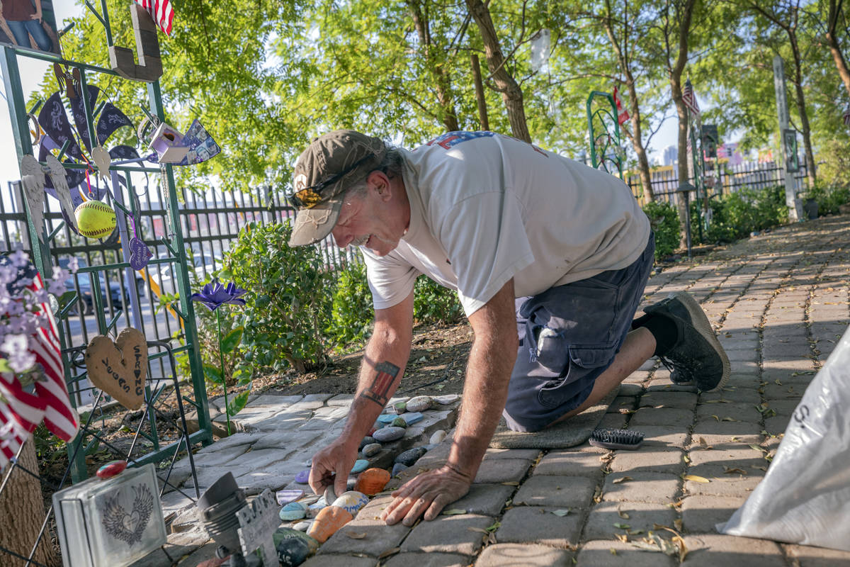 Caretaker of the Healing Garden Eddie Schmitz works Sept. 14 on memorial trellises for victims ...