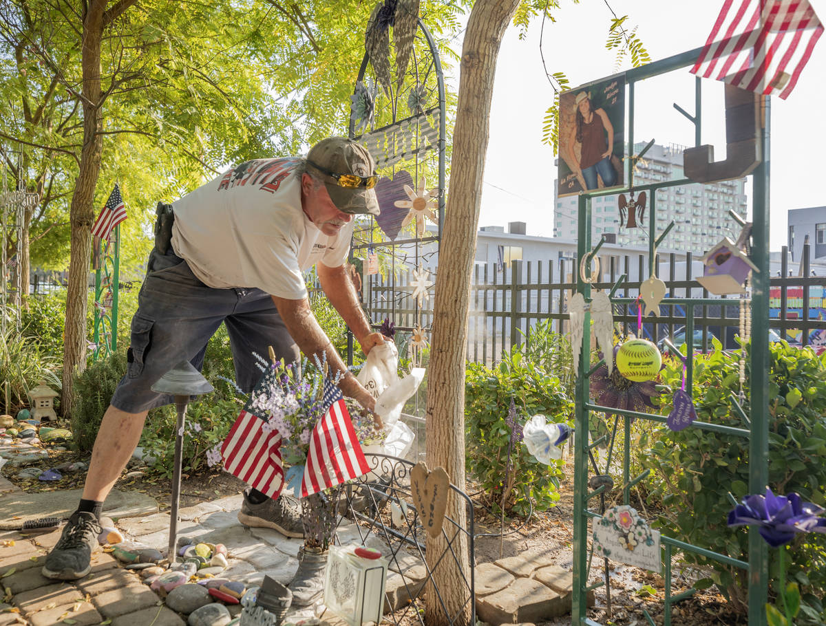 Caretaker of the Las Vegas Healing Garden Eddie Schmitz works on restoring individual memorial ...