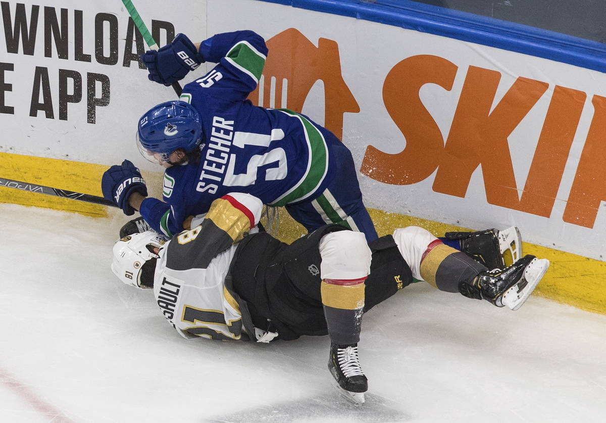 Vancouver Canucks' Troy Stecher (51) checks Vegas Golden Knights' Jonathan Marchessault (81) du ...