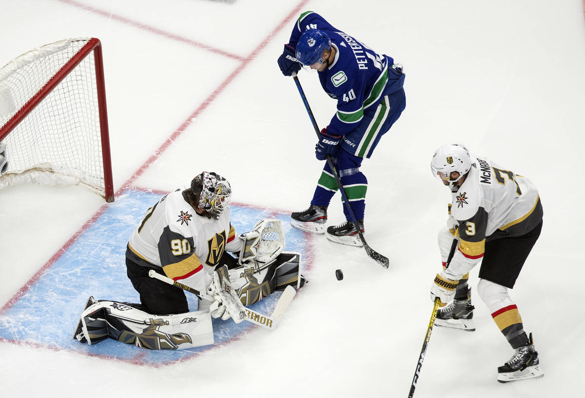 Vancouver Canucks' Elias Pettersson (40) is stopped by Vegas Golden Knights goalie Robin Lehner ...