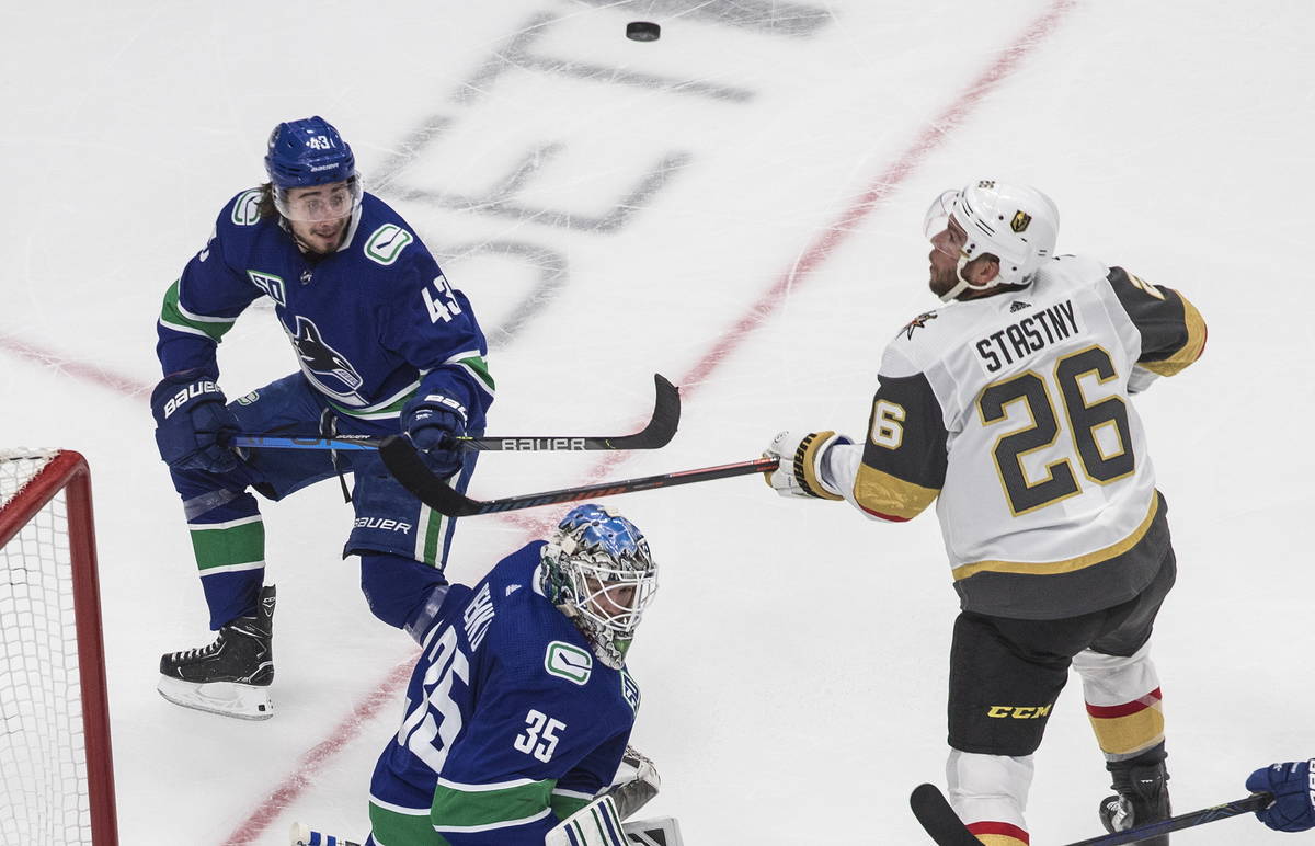 Vancouver Canucks goalie Thatcher Demko (35), Vegas Golden Knights' Paul Stastny (26) and Canuc ...
