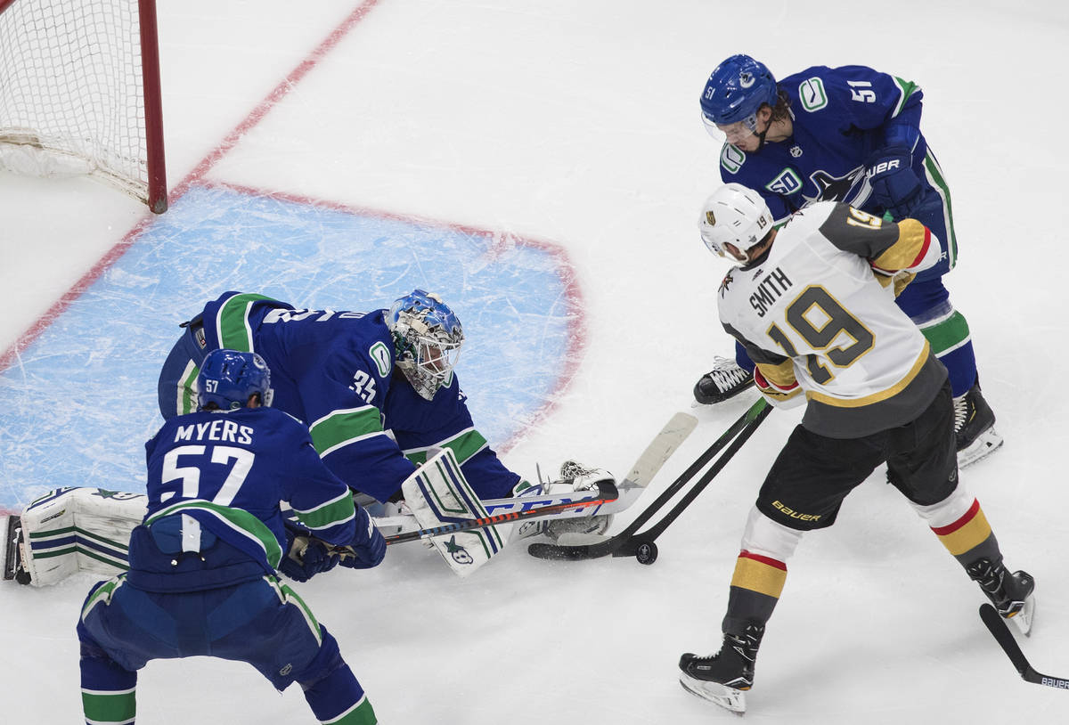 Vancouver Canucks goalie Thatcher Demko (35) makes a save on Vegas Golden Knights' Reilly Smith ...