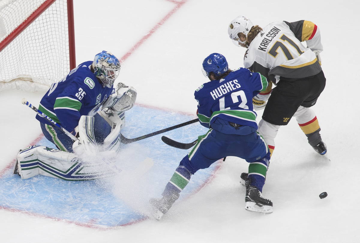 Vancouver Canucks goalie Thatcher Demko (35) makes a save as Vegas Golden Knights' William Karl ...