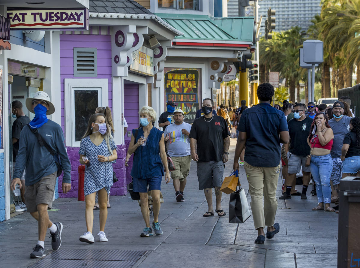 Visitors wander past and in line at Fat Tuesday along the Strip on Friday, August 7, 2020, in L ...