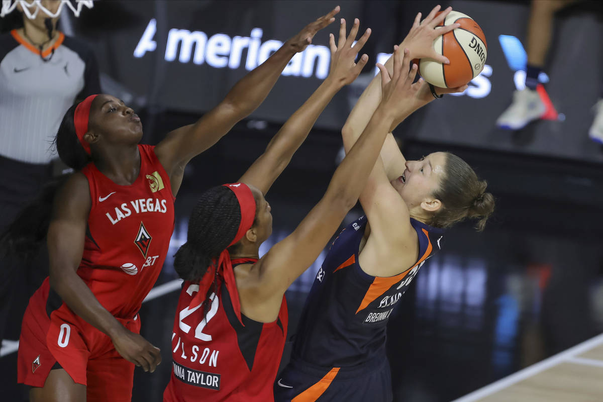 Connecticut Sun's Theresa Plaisance, right, shoots ovr Las Vegas Aces' Jackie Young (0) and A'j ...
