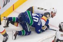 Vancouver Canucks' Elias Pettersson (40) and Vegas Golden Knights' Paul Stastny (26) rough it u ...