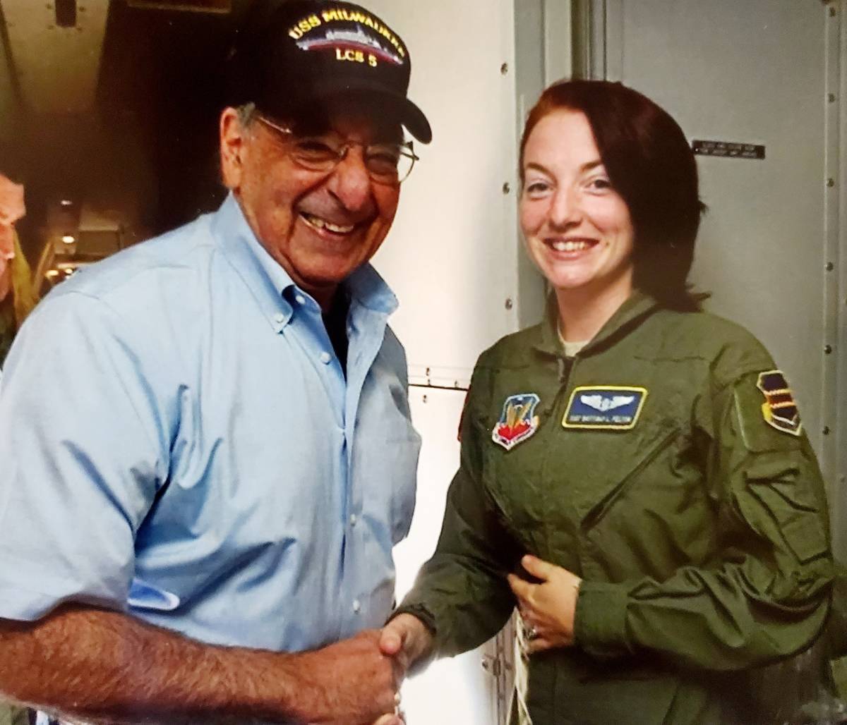 Brittinay Lenhart at 24, and former Secretary of Defense, Leon Panetta, shaking hands on his la ...