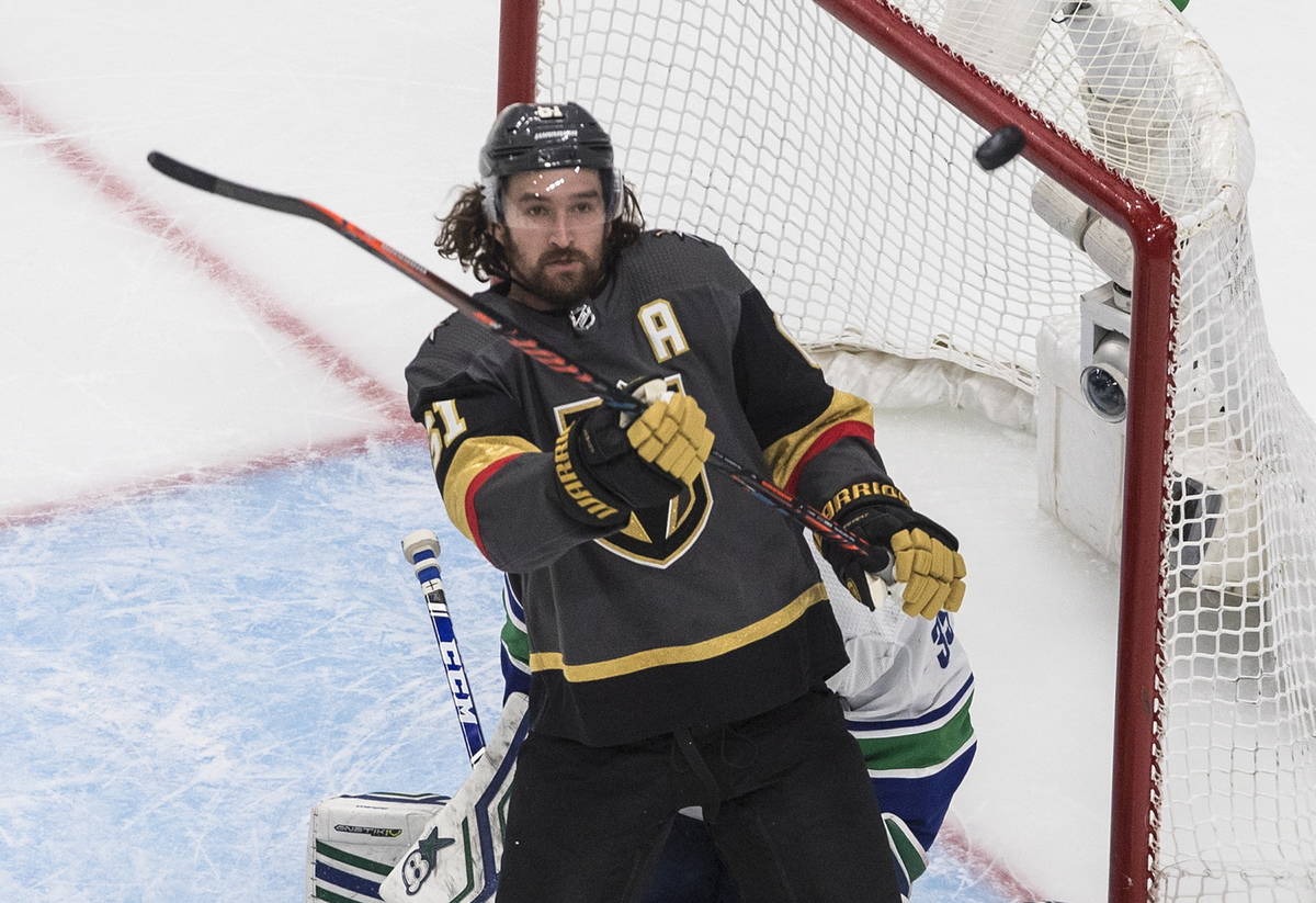 Vegas Golden Knights' Mark Stone (61) tries for the rebound next to Vancouver Canucks goaltende ...