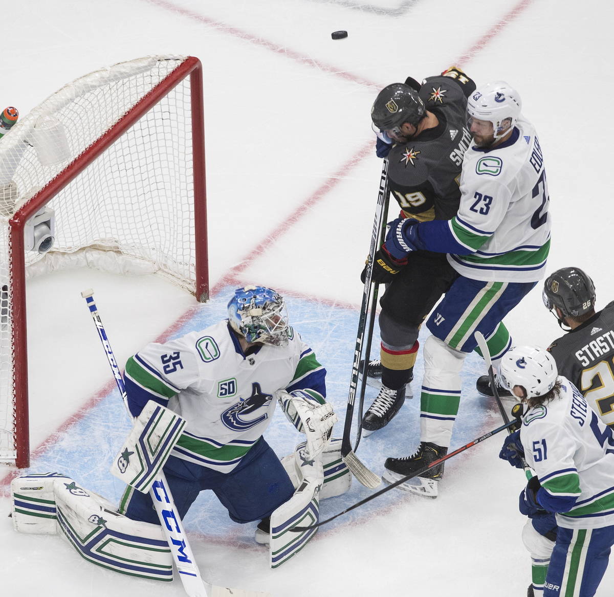 Vancouver Canucks goalie Thatcher Demko (35) makes a save on Vegas Golden Knights' Reilly Smith ...