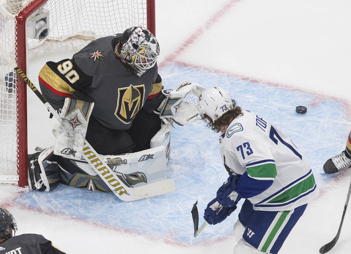Vancouver Canucks' Tyler Toffoli (73) is stopped by Vegas Golden Knights goalie Robin Lehner (9 ...