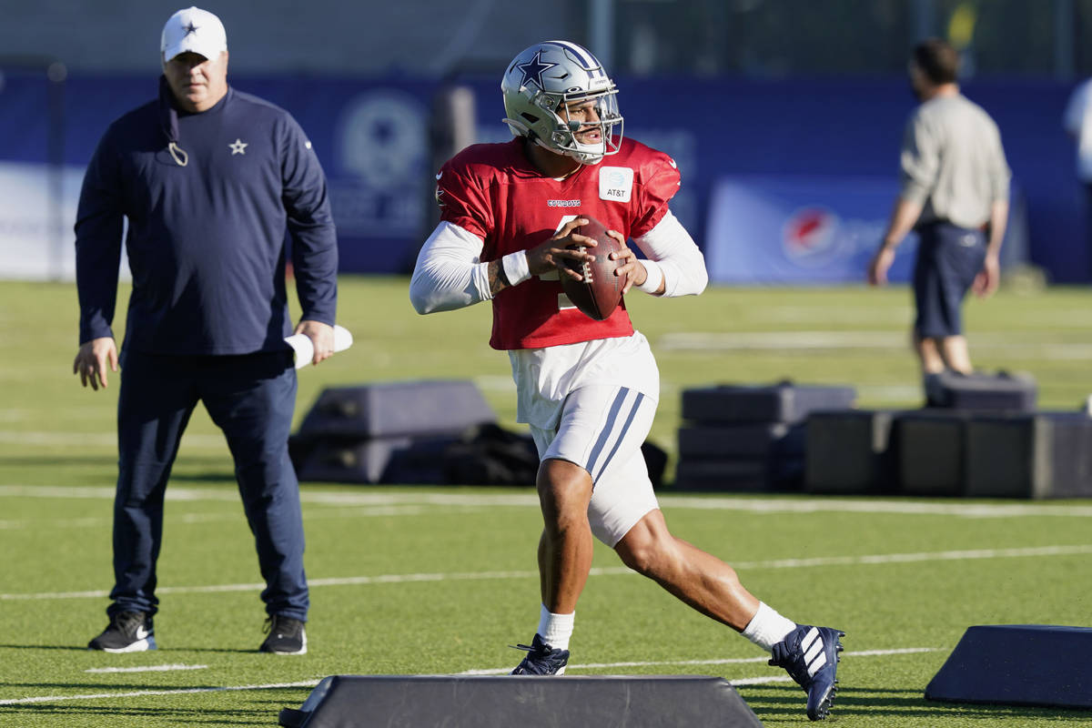 Dallas Cowboys quarterback Dak Prescott (4) works a passing drill as head coach Mike McCarthy l ...