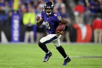 Baltimore Ravens quarterback Lamar Jackson (8) scrambles during the second half of an NFL divis ...