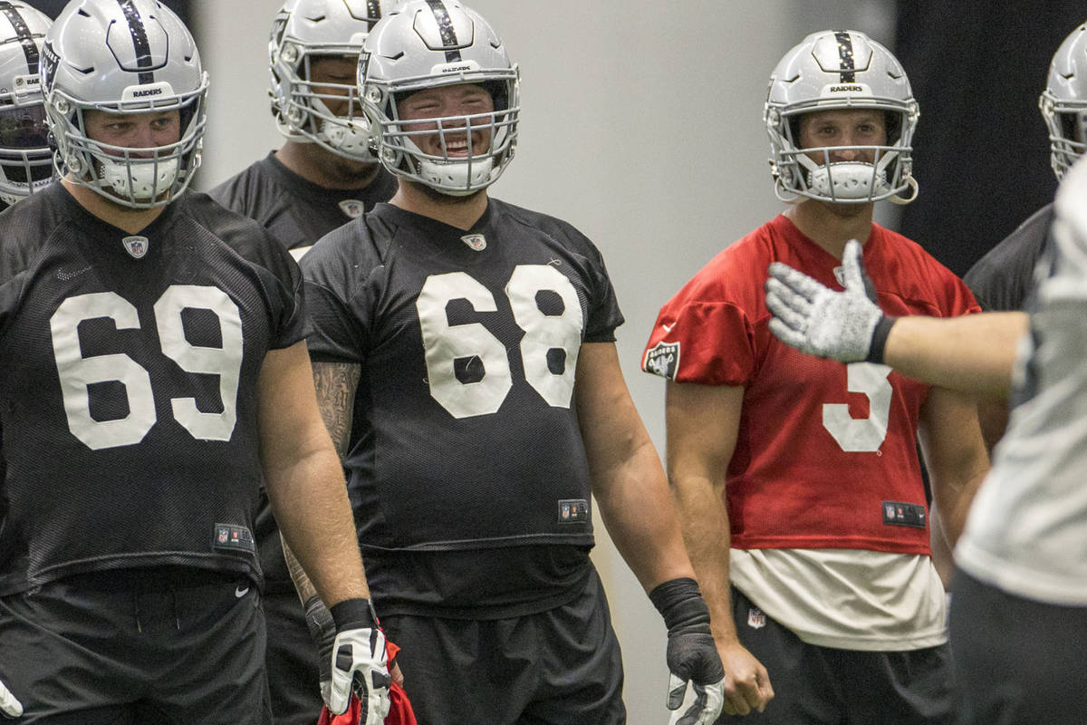 (From left) Las Vegas Raiders guard Eric Kush (69), offensive tackle Andre James (68) and quart ...