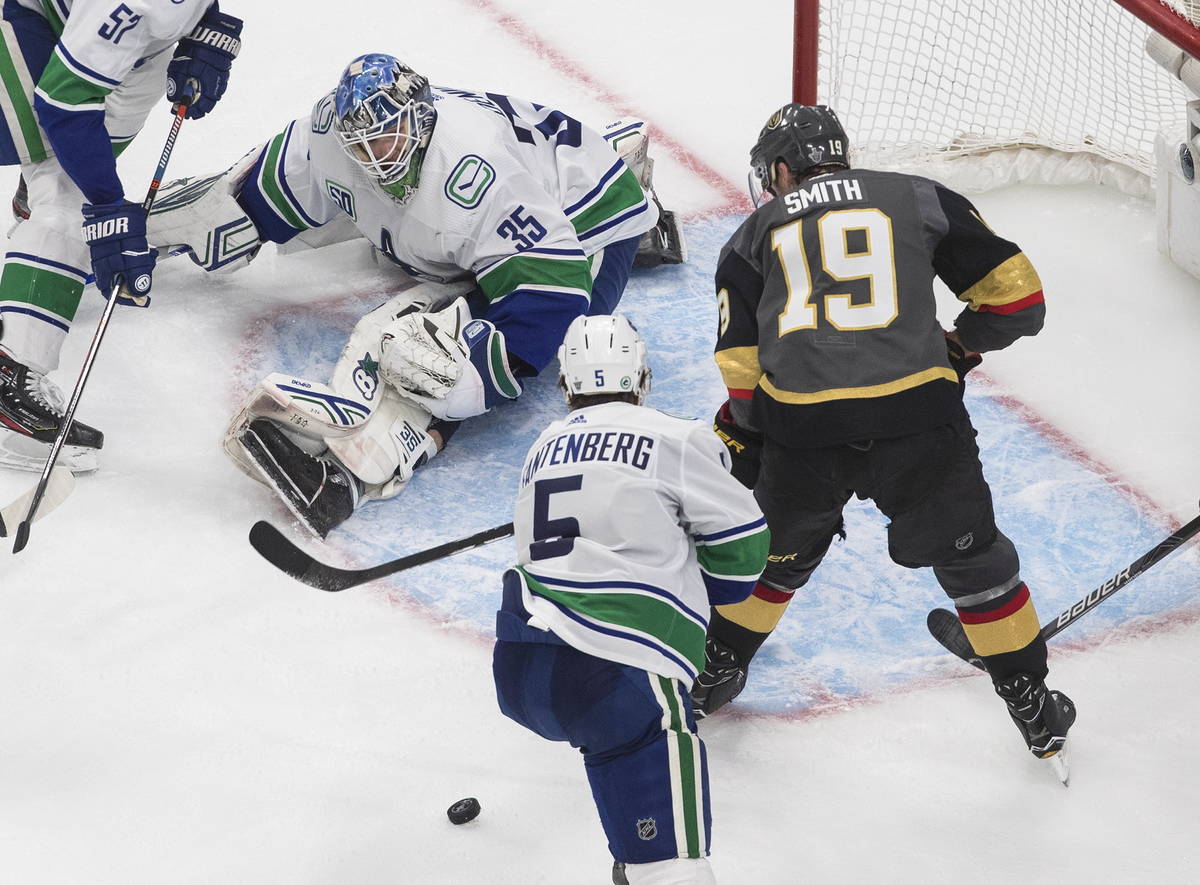 Vancouver Canucks goalie Thatcher Demko (35) makes a save on Vegas Golden Knights' Reilly Smith ...