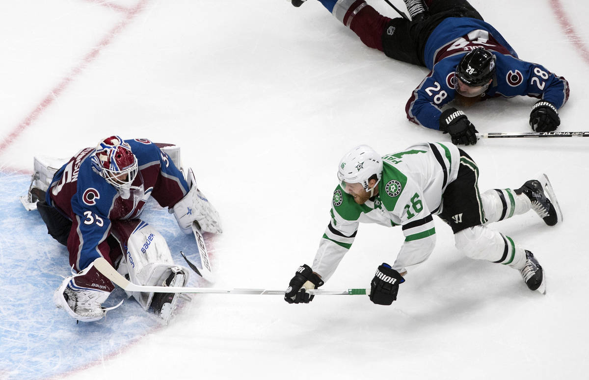Colorado Avalanche goalie Michael Hutchinson (35) makes a save against Dallas Stars' Joe Pavels ...