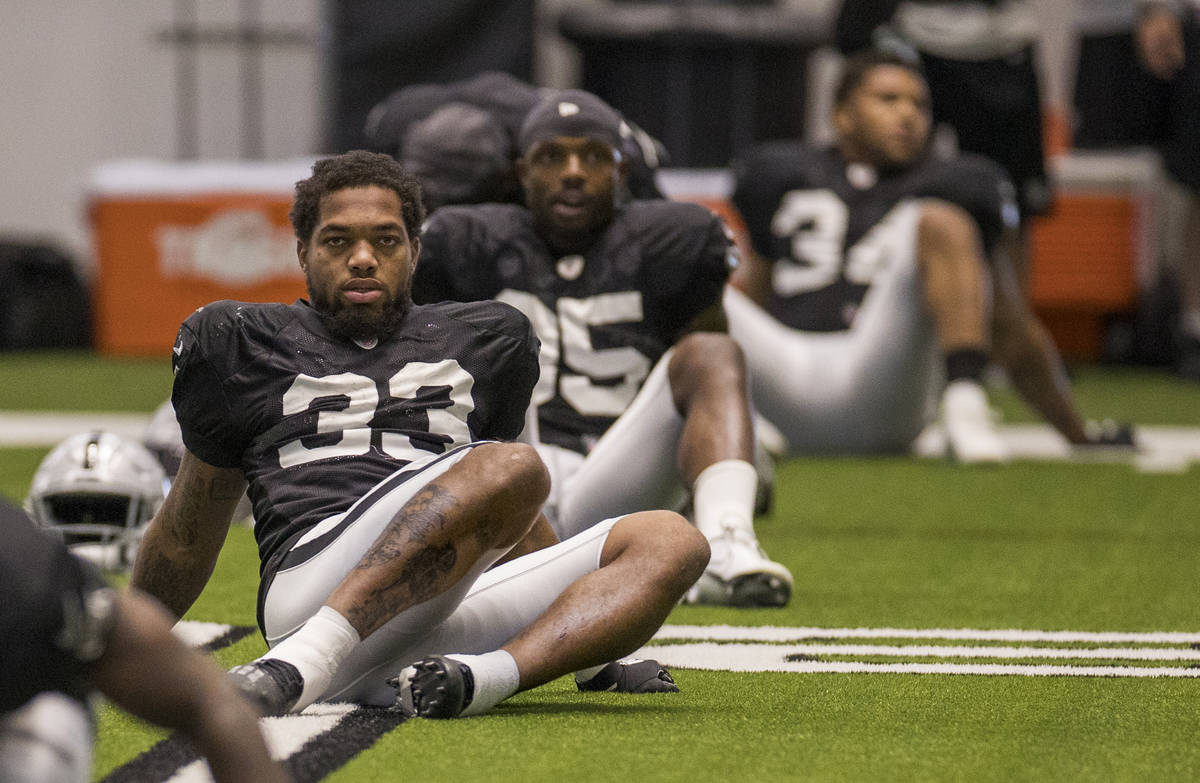 Las Vegas Raiders running back Lynn Bowden Jr. (33) stretches with teammates during warm ups at ...