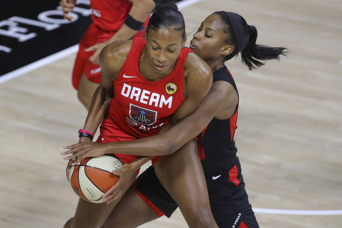Atlanta Dream's Betnijah Laney, left, is defended by Las Vegas Aces' Lindsay Allen during the f ...