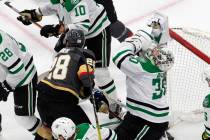 Dallas Stars goalie Ben Bishop (30) is hit by Vegas Golden Knights' William Carrier (28) during ...