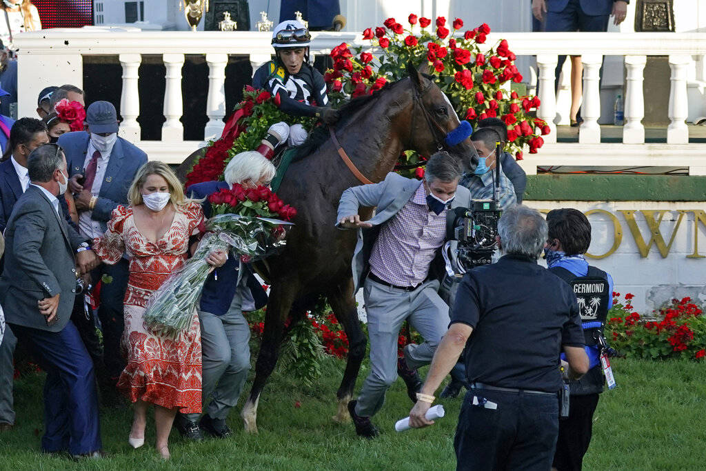 Trainer Bob Baffert attempts to get out of the way as Jockey John Velazquez tries to control Au ...