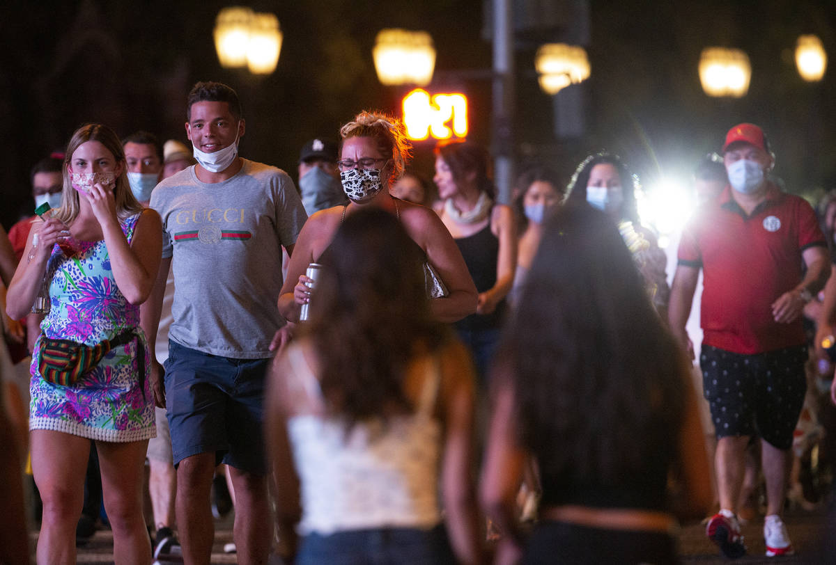 Visitors cross Las Vegas Boulevard from the Bellagio toward Paris during Labor Day weekend on S ...