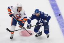 Tampa Bay Lightning's Kevin Shattenkirk (22) and New York Islanders' Anders Lee (27) battle for ...
