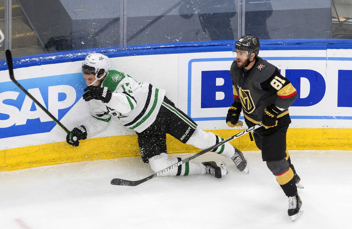 Vegas Golden Knights' Jonathan Marchessault (81) checks Dallas Stars' Mattias Janmark (13) duri ...