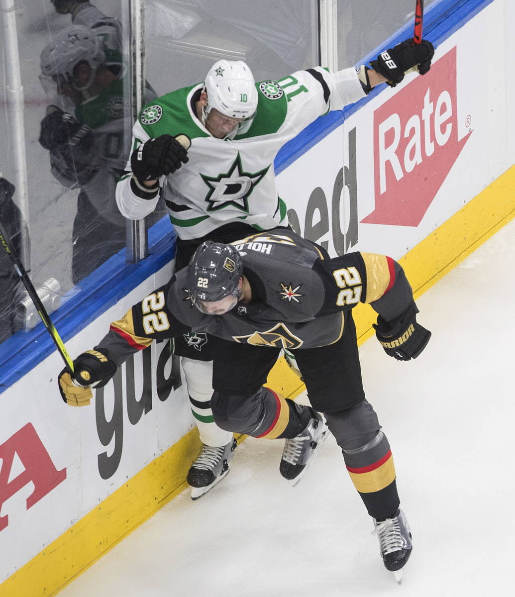 Vegas Golden Knights' Nick Holden (22) checks Dallas Stars' Corey Perry (10) during the first p ...