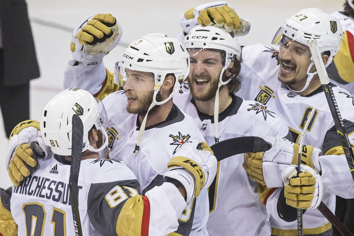 Golden Knights center Jonathan Marchessault (81) hugs teammates Brayden McNabb (3), Colin Mille ...