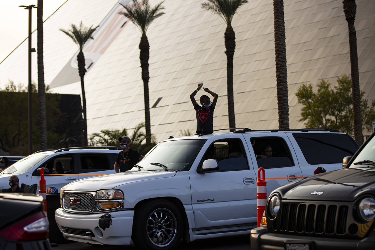 Jyrell Fletcher, 9, of North Las Vegas, cheers during a drive-in showing of the Las Vegas Aces ...