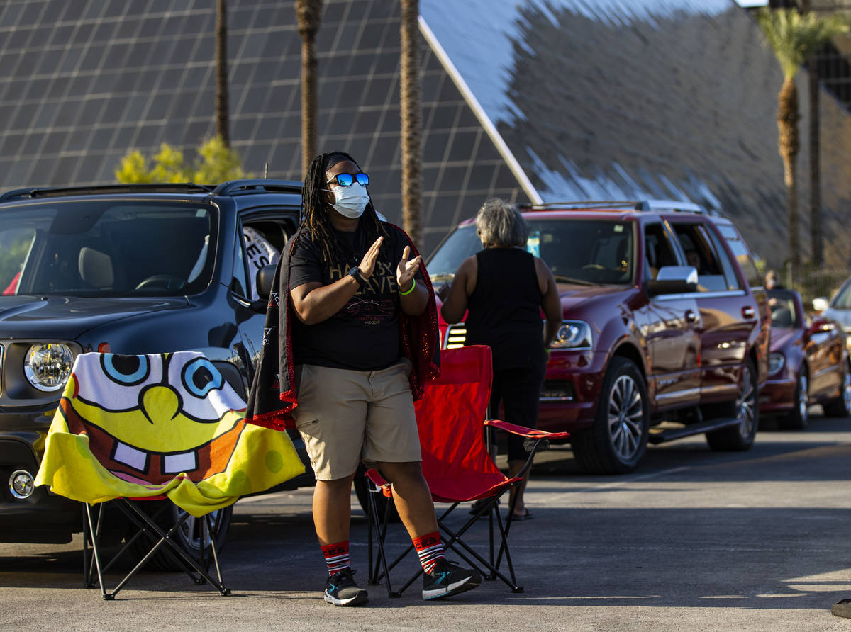 Las Vegas Aces fan Cassie Jemison, of Henderson, cheers at the start of a drive-in showing of t ...