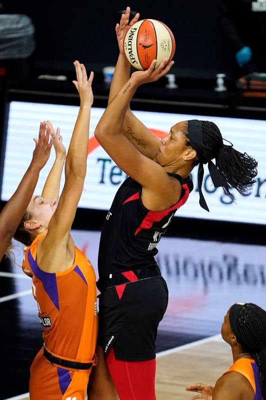 Las Vegas Aces center A'ja Wilson (22) shoots over Phoenix Mercury forward Alanna Smith (11) du ...